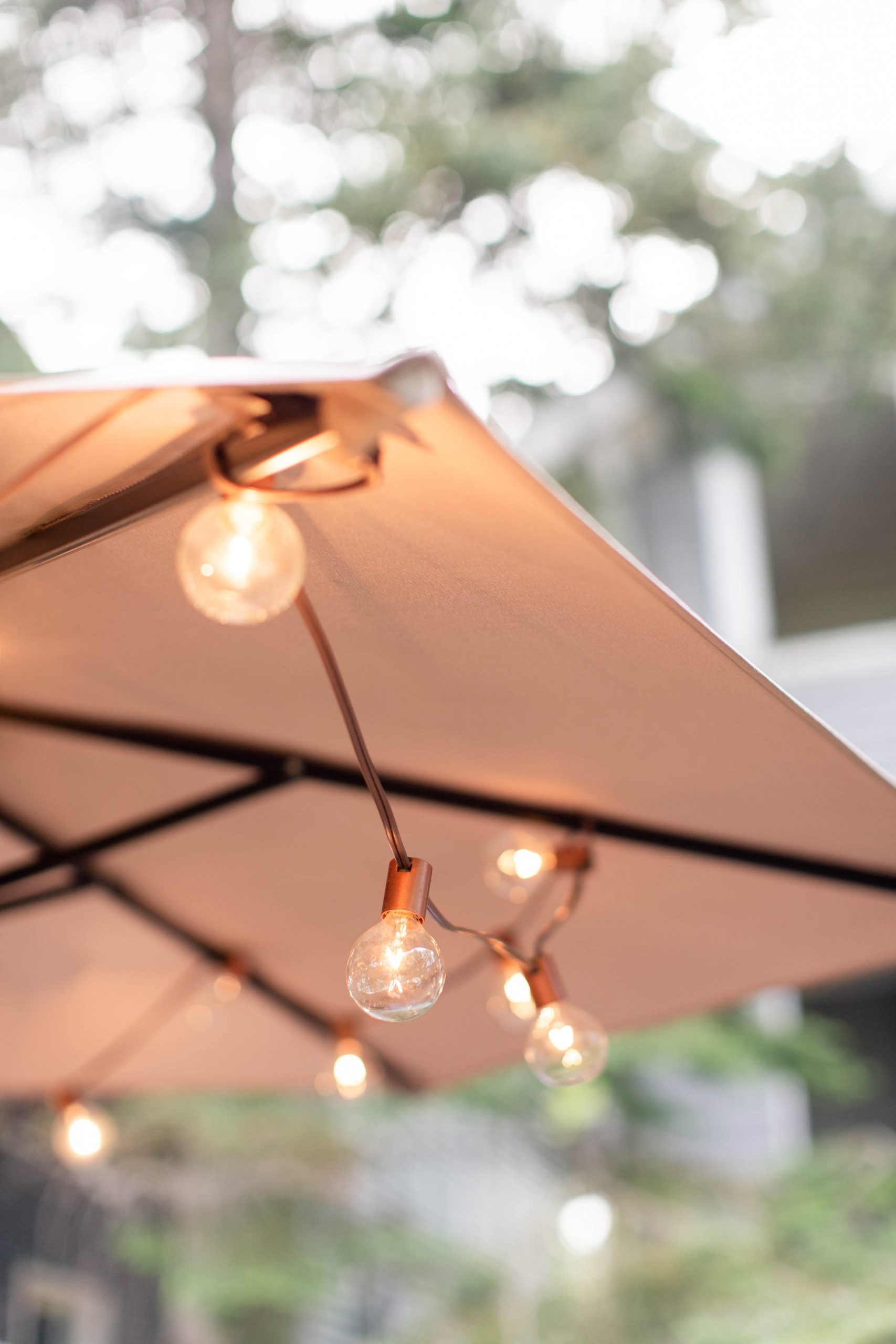 mini bulb lights strung through patio umbrella